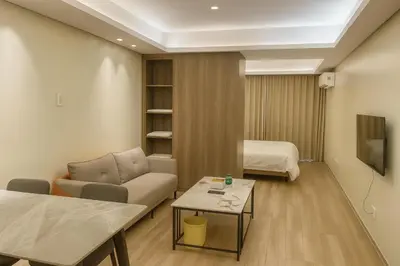 a living room with a couch and a bed at Manila City Center Executive Apartments near Ayala Mall and PITX in Manila
