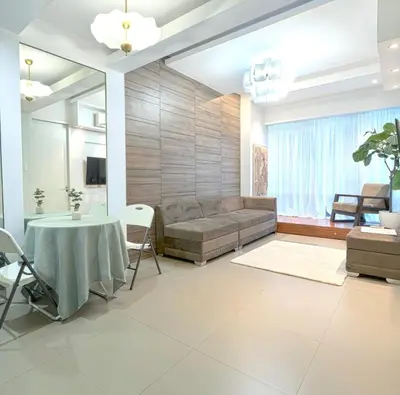 a living room with a couch and a table at Haven in the Park in Manila