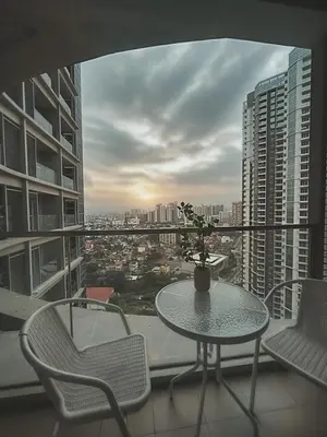 a table and chairs on a balcony with a view at Uptown Parksuites Sun scenic city escape 22T in Manila