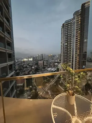a balcony with a table and a view of a city at Uptown Parksuites Sun scenic city escape 22T in Manila