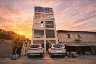 two white cars parked in front of a building at Lunan by SKI - Boutique Hotel in Taytay Rizal in Taytay