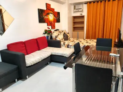 a living room with a couch and a table at 1 bedroom Condotels Across terminal 3 airport in Manila