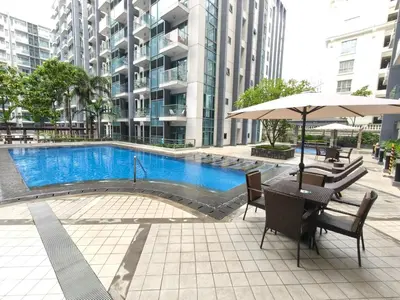 a table with an umbrella next to a swimming pool at 1 bedroom Condotels Across terminal 3 airport in Manila