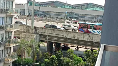 a bus and cars on a bridge in a city at 1 bedroom Condotels Across terminal 3 airport in Manila
