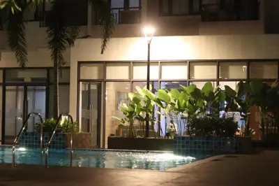 a building with a swimming pool at night at Cozy & Affordable Staycation Melrose Haven in Manila