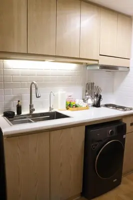a kitchen with a sink and a dishwasher at Cozy & Affordable Staycation Melrose Haven in Manila