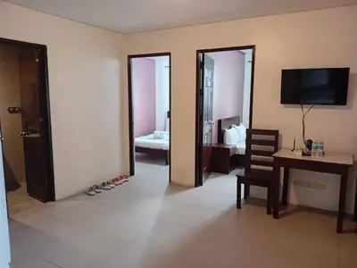 a room with a desk and a room with a bedroom at Shandong Residences in Manila