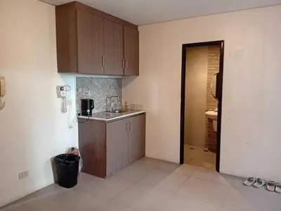 a small kitchen with a sink and a counter at Shandong Residences in Manila