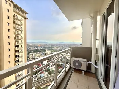 a balcony with a view of a city at Spacious 3BR 2 balcony Resort vibes near BGC in Manila