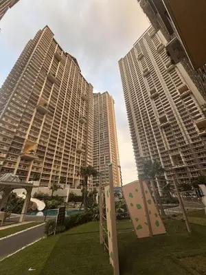 two tall buildings with a park in front of them at Spacious 3BR 2 balcony Resort vibes near BGC in Manila