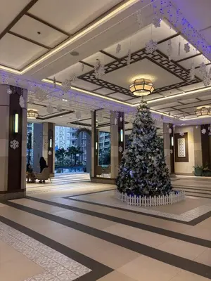 a christmas tree in the middle of a lobby at Spacious 3BR 2 balcony Resort vibes near BGC in Manila