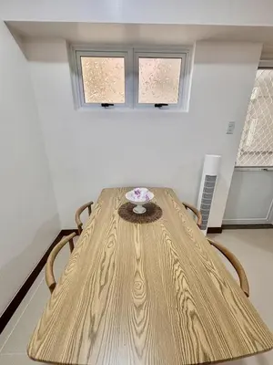 a table in a room with two windows at Spacious 3BR 2 balcony Resort vibes near BGC in Manila