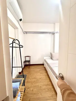 a small room with a bed and a window at Spacious 3BR 2 balcony Resort vibes near BGC in Manila