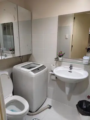 a white bathroom with a toilet and a sink at Juliza Staycation near Mall Of Asia in Manila