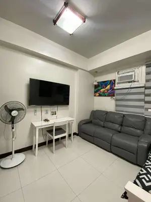 a living room with a couch and a table at Vienna's Condotel in Manila