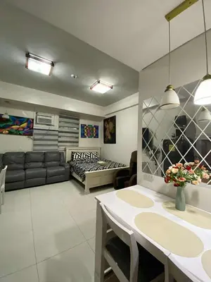 a living room with a couch and a table at Vienna's Condotel in Manila