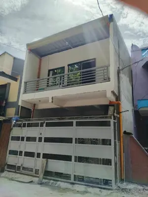 a building with a balcony on top of it at AET Staycation House in San Pedro