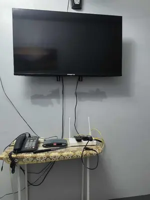 a flat screen tv sitting on a table with a keyboard at AET Staycation House in San Pedro