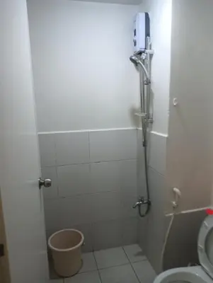 a bathroom with a shower and a toilet at pierrecondotel in Manila