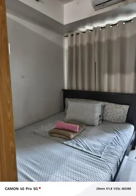 a small bed in a room with a curtain at Moa view sea Residences condotel in Manila