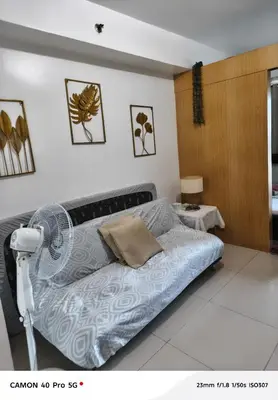 a bedroom with a bed and a fan at Moa view sea Residences condotel in Manila