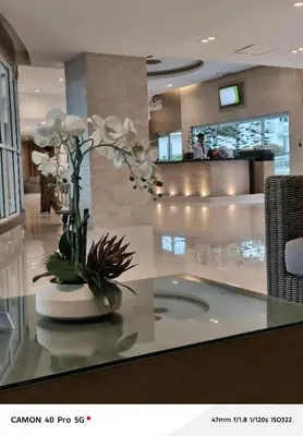 a lobby with a vase with white flowers on a table at Moa view sea Residences condotel in Manila