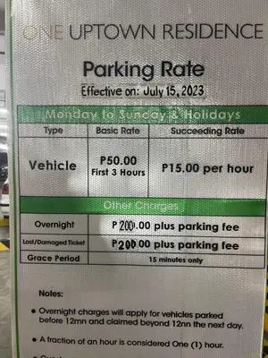 a parking rate sign for a parking lot at Modern & Stylish Condo at One Uptown Residence in Manila