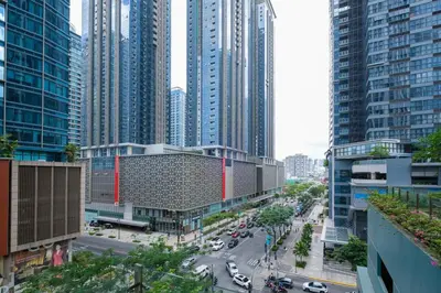 a view of a city street with tall buildings at Modern & Stylish Condo at One Uptown Residence in Manila