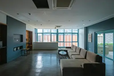 a living room with a couch and a table at Modern & Stylish Condo at One Uptown Residence in Manila
