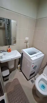 a bathroom with a sink and a toilet in it at JCs Staycation Fame Residences in Manila