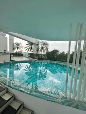 a swimming pool on the balcony of a building at Roomi Stays Acqua Private Residences in Manila
