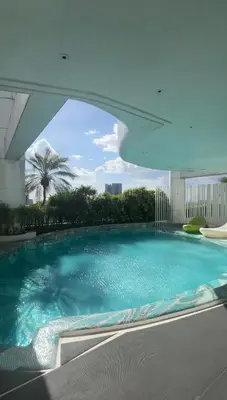 a large swimming pool inside of a building at Roomi Stays Acqua Private Residences in Manila