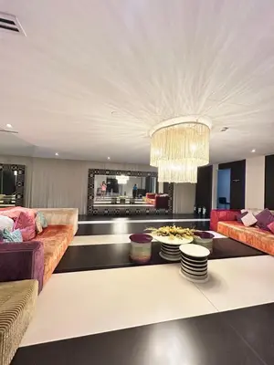 a living room with a couch and a table at Roomi Stays Acqua Private Residences in Manila