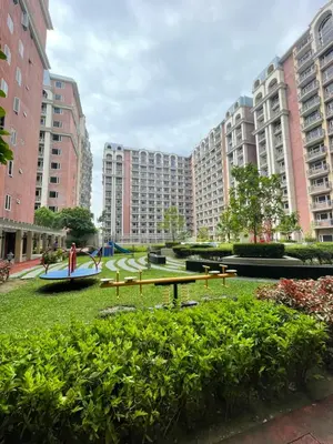 a park with a picnic table in the middle of buildings at D'Hauz 2- Pet Friendly unit in Manila