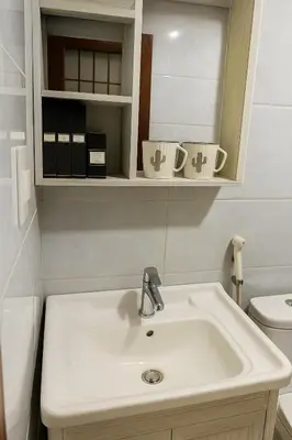 a bathroom with a white sink and a toilet at T1 Stay Airport Residences - Tower A in Manila