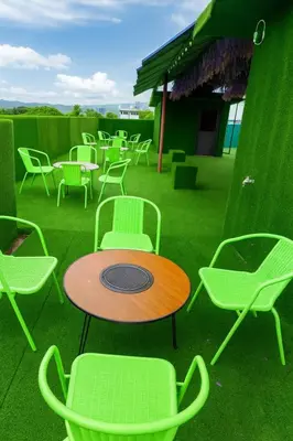 a group of chairs and a table and chairs at T1 Stay Airport Residences - Tower A in Manila
