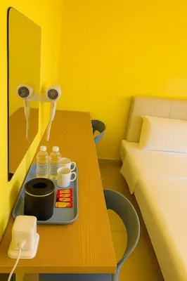a room with a bed and a table with a tray of food at T1 Stay Airport Residences - Tower A in Manila