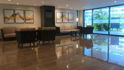 a lobby with a couch and chairs and a table at Prime Makati CBD Condo with Fast WiFi in Manila