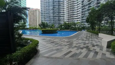 a swimming pool in a city with tall buildings at Prime Makati CBD Condo with Fast WiFi in Manila