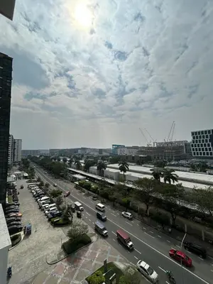 a view of a busy city street with cars at Cozy 1 BR unit at Shore 1 Residences Mall of Asia in Manila