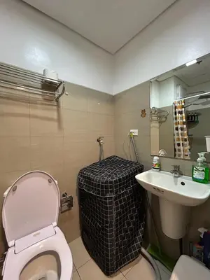 a bathroom with a pink toilet and a sink at Cozy 1 BR unit at Shore 1 Residences Mall of Asia in Manila