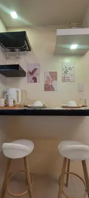 two white stools sitting at a counter in a kitchen at Staycation by Jia cozy corner in Manila