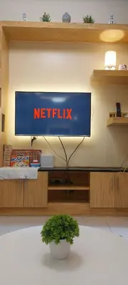 a netflix sign on a wall in a room at Staycation by Jia cozy corner in Manila