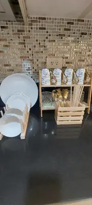 a room with a table and some plates and bowls at Staycation by Jia cozy corner in Manila