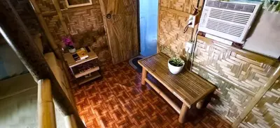 an overhead view of a room with a bench and a plant at CLBC Bahay Kubo in Tagapo