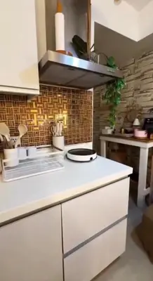 a kitchen with a white counter top in a room at Azure SYM Staycation in Manila