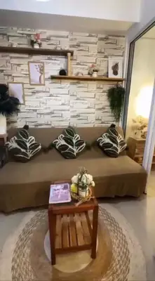 a living room with a bed and a coffee table at Azure SYM Staycation in Manila