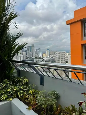 a balcony with a view of a city skyline at Sunshine100 1Bedroom 65InchesTV PoolGymBilliardPlayground in Manila