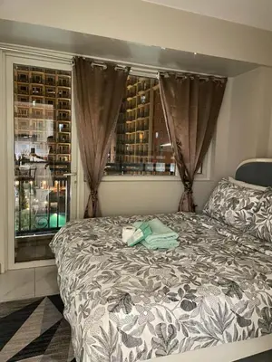 a bedroom with a bed in front of a window at D'Hauz 3 - Pet Friendly unit in Manila
