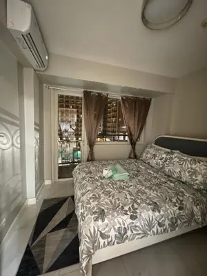 a bedroom with a bed and a window at D'Hauz 3 - Pet Friendly unit in Manila